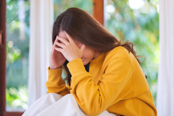 istock A woman get sick and headache at home 2202288758