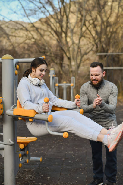 istock Boyfriend Cheering on Girlfriend While She's Beating Her Personal Best in Abs Exercise 2202288874