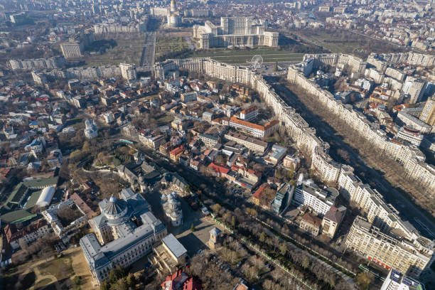 Bucharest, Romania - January 1, 2025: Aerial drone view over Bucharest downtown cityscape. Palace of Parliament, National Salvation Cathedral, The Patriarchal Cathedral and Boulevard Unirii.