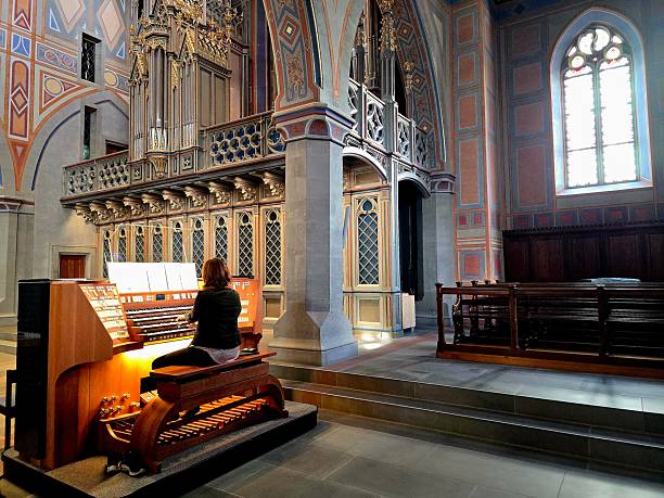 The Church of St. Laurenzen is the Evangelical Reformed parish church of the city of St. Gallen. The construction of the first church can be dated to the middle of the 12th century. The image show a Pipe Organ player inside the beautiful church.