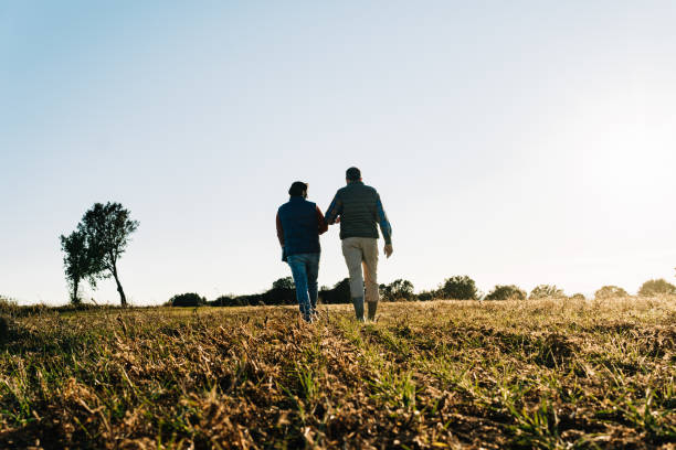 istock Two farmers walking and discussing in their field 2202289926
