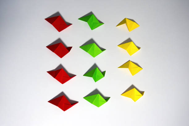 istock High angle view of colorful folded origami paper sheets ready to be connected to a cube. 2202291937