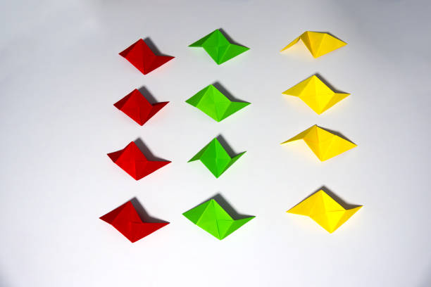istock High angle view of colorful folded origami paper sheets ready to be connected to a cube. 2202291940