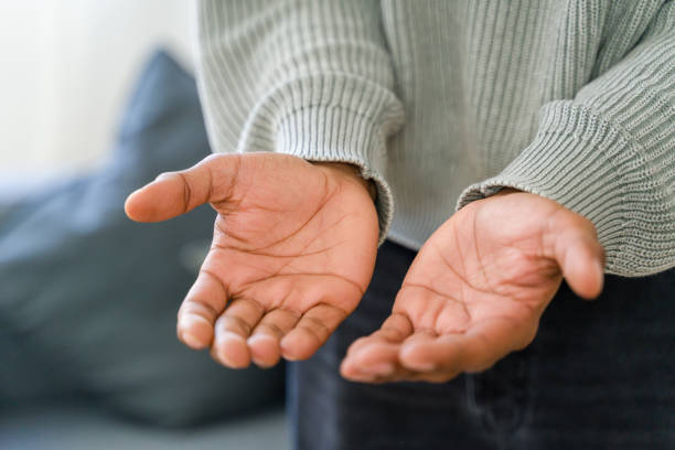 Charity, protection and care concept. Black male hands keep empty cupped palms together isolated on studio white background