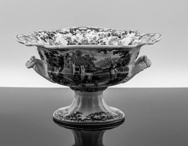 Elegant Porcelain Bowl With Intricate Design Displayed on Reflective Surface in Soft Light