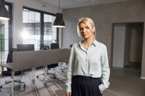 istock Happy young woman on first working day in office 2202296840