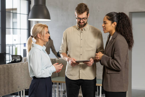 istock Colleagues introduce a new coworker to the job 2202297628