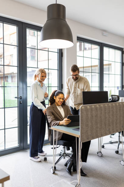 istock Experienced colleagues helping the new employee 2202298649