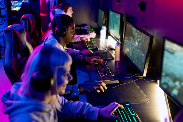 istock Professional gamers playing video games in internet cafe 2202299333
