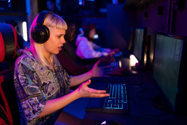 istock Professional female gamer playing in eSports competition using computer and headset 2202299433
