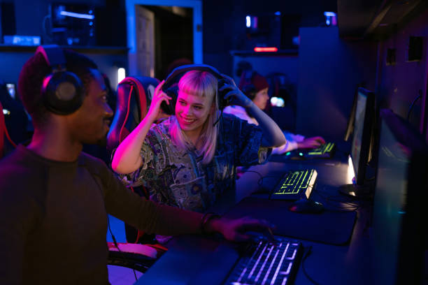 istock Pro gamers playing video games in internet cafe 2202299437