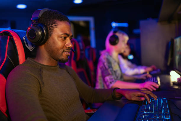 istock Focused gamer playing video game in gaming room 2202299439