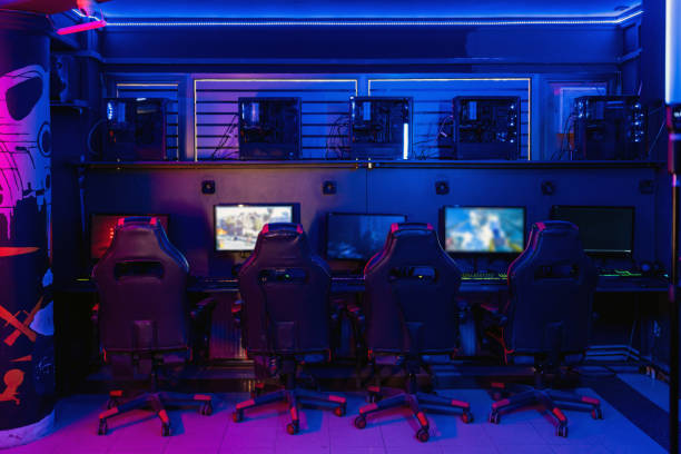 istock Empty gaming chairs in internet cafe lit by neon lights 2202299504