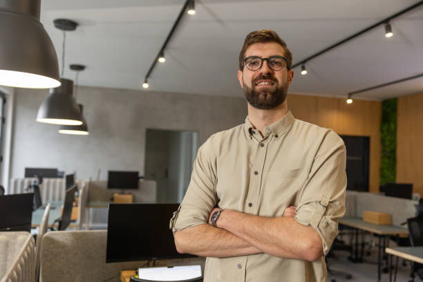 istock Happy young man on first working day in office 2202299764