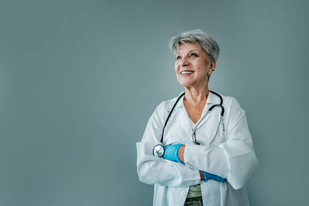 istock Doctor looking away on a gray background on a studio shot 2202301724