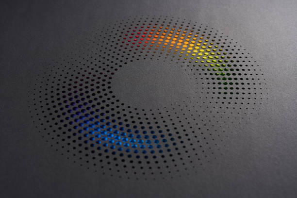 istock Modern cut paper artwork with circular perforations revealing a vibrant gradient of blue, green, yellow, and red hues. 2202303771