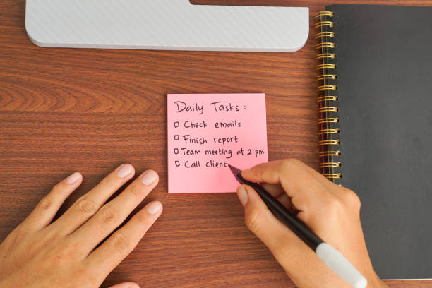istock Hand Writing Daily Task on Sticky Note for Daily Planning 2202304642
