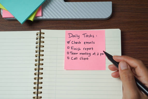 istock Hand Writing Daily Task on Sticky Note for Daily Planning 2202304678