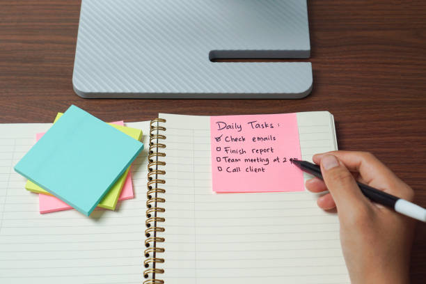 istock Hand Writing Daily Task on Sticky Note for Daily Planning 2202304841
