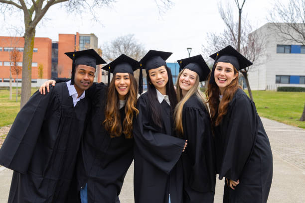 istock Happy multiethnic students celebrating graduation day at university campus 2202305782