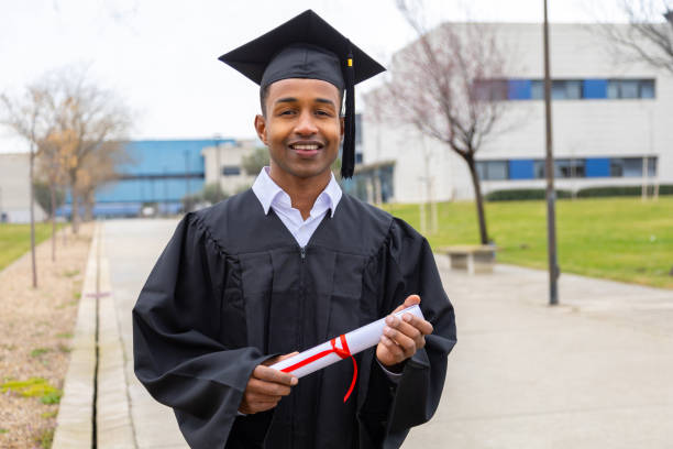 istock Happy graduate student holding diploma walking in university campus 2202305786