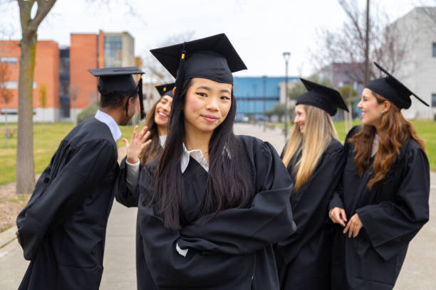 istock Young graduates celebrating graduation day at university campus 2202305794