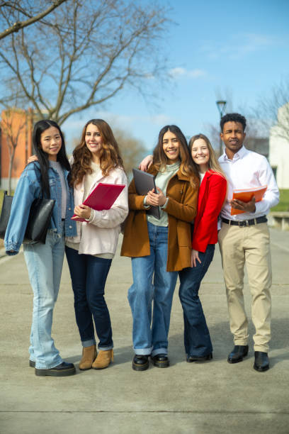 istock Happy students standing together on university campus 2202305833