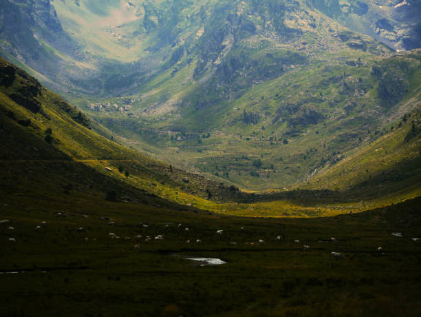 wide valley of a mountain landscape with shadow and sun contending
