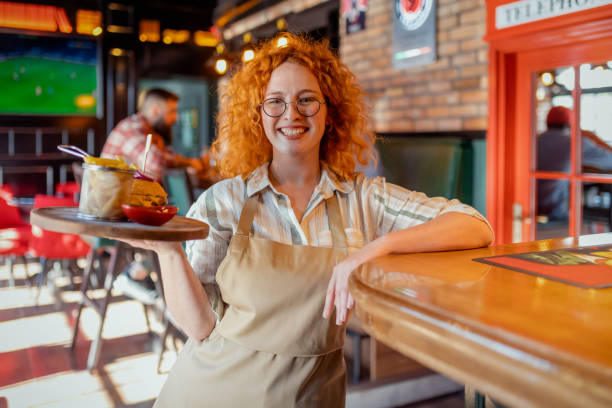 Smiling Waitress Serving Food at a Restaurant