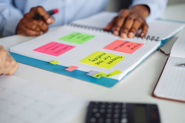 istock Close-Up of Business Team Collaborating Using Sticky Notes for Planning 2202308893