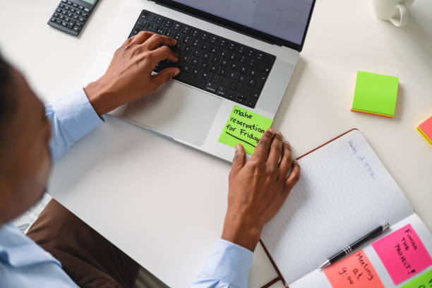 African American Man Planning Tasks with Sticky Notes in Office