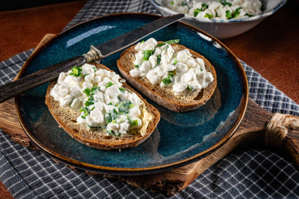 istock Slices of bread with cottage cheese and green onion. 2202309101