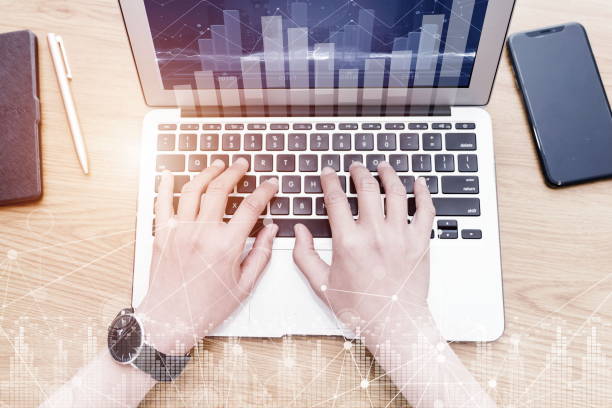 istock Abstract financial diagram with hand typing on computer keyboard on background, banking and accounting concept, Big Data Technology for Business Finance Analytic Concept. 2202309595