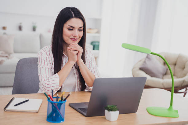 istock Portrait of attractive trendy focused long-haired woman study learn education reading web book literature at light house indoors 2202313650