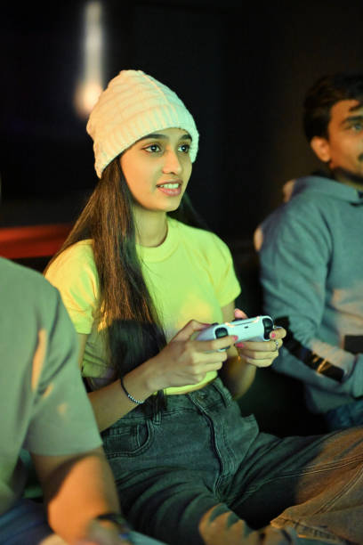 istock Young female immersed in gaming with controller in hand 2202314358