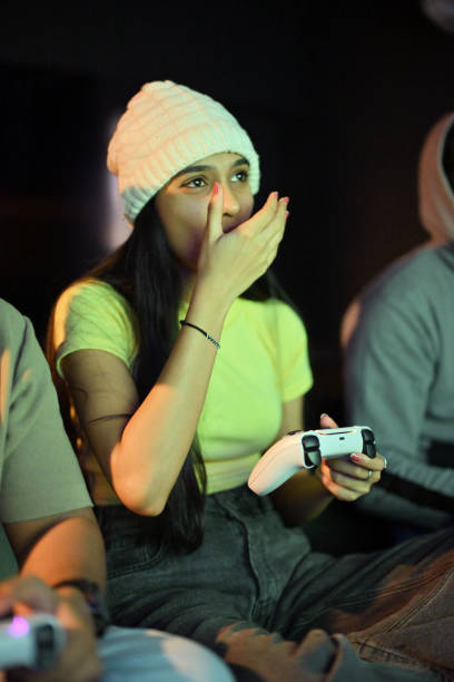 istock Young woman bursts into laughter while playing video game at a gaming hub 2202314464