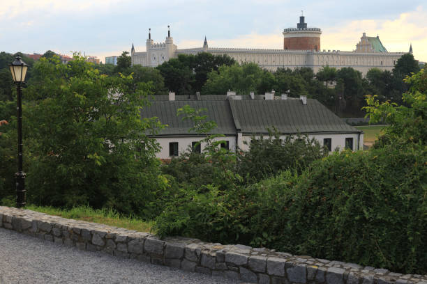 Lublin, Poland - July 04, 2024: Photo with a view of Lublin Castle, greenery and lantern in the historic city center