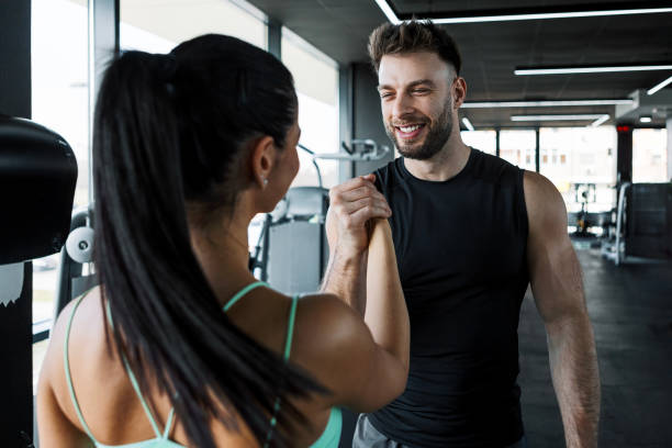 istock Female Client and Personal Trainer In Gym 2202315699