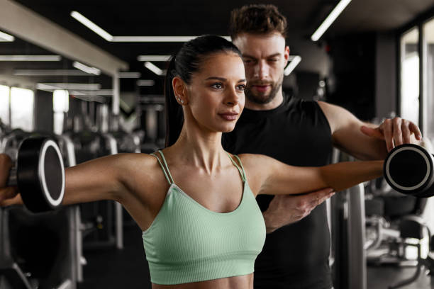 istock Working Out with Dumbbells With Fitness Instructor 2202315707