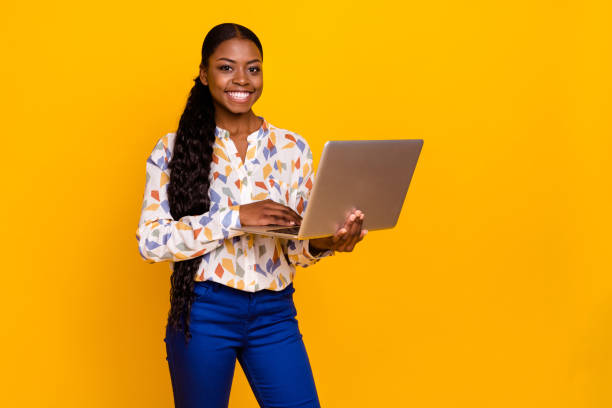 istock Portrait of attractive cheerful skilled girl using laptop developing web it project startup isolated over bright yellow color background 2202320308