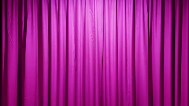 istock A luxurious, textured pink fabric curtain, draped in soft folds and illuminated with a subtle glow, creates an elegant and versatile background. 2202325762