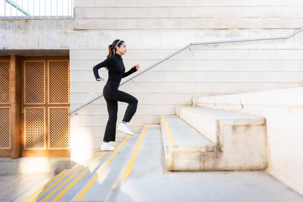 istock Sportswoman running upstairs 2202326800