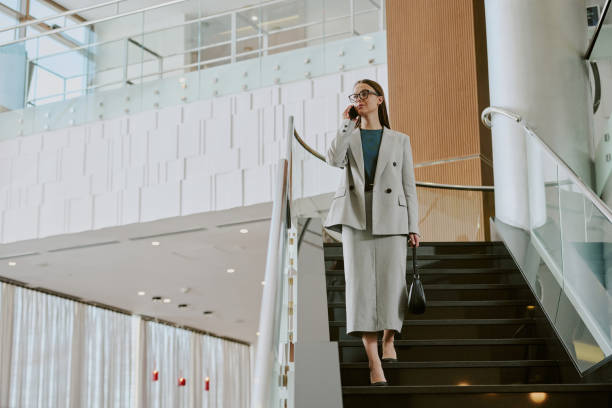 istock Serious Businesswoman Going Down Stairs 2202327206