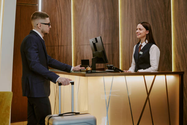 istock Receptionist Greeting Guest of Hotel 2202327283