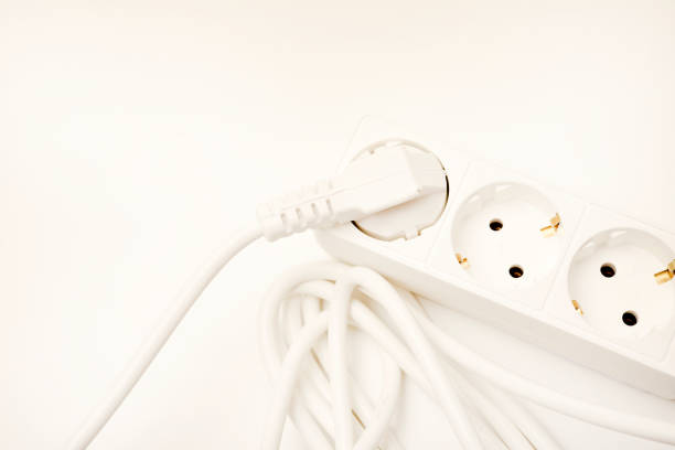 An extension cord with three sockets. White wire with sockets on a white background.