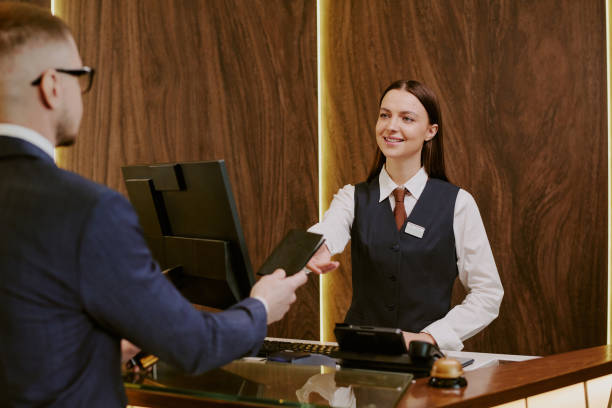 istock Unrecognizable Man Giving Passport to Receptionist 2202327475