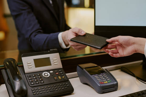 istock Hand Holding Passport above Desk 2202327500