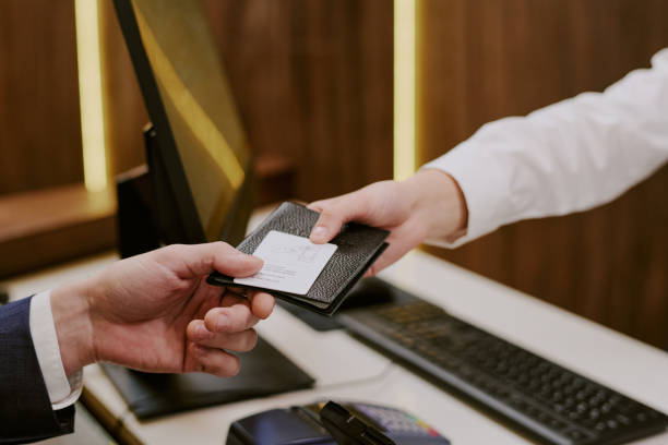 istock Man Taking His Passport and Room Key 2202327523