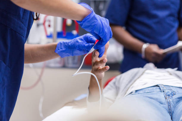 istock Healthcare Worker Attaching Medical Sensor to Patient 2202327853