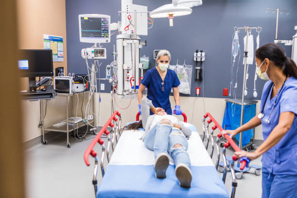 istock Patient Care: Two Nurses Assisting a Female Patient 2202327857